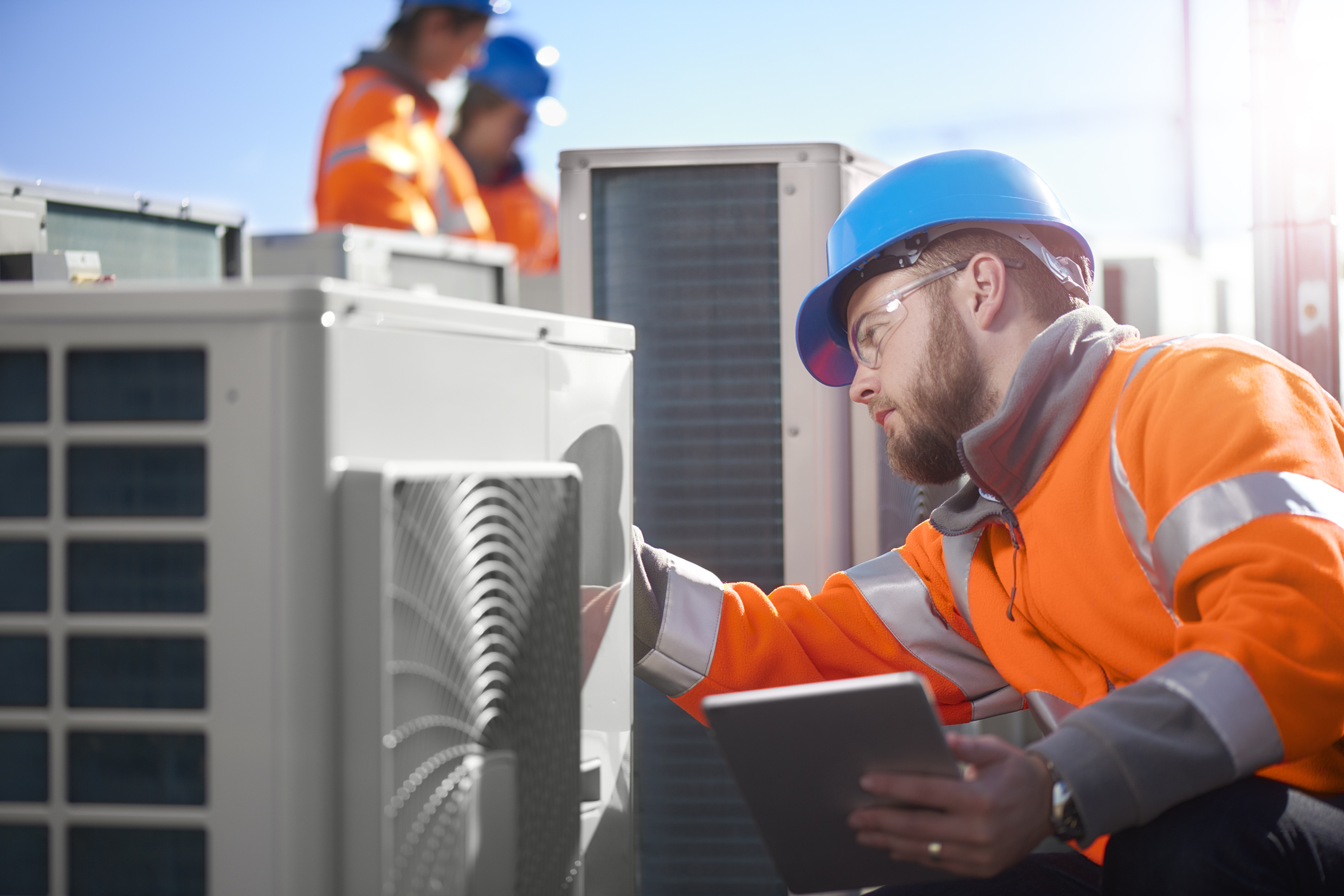Pro Air technicians on a rooftop servicing air-conditioning equipment